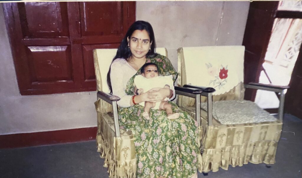 Photo of woman sitting down and holding a baby